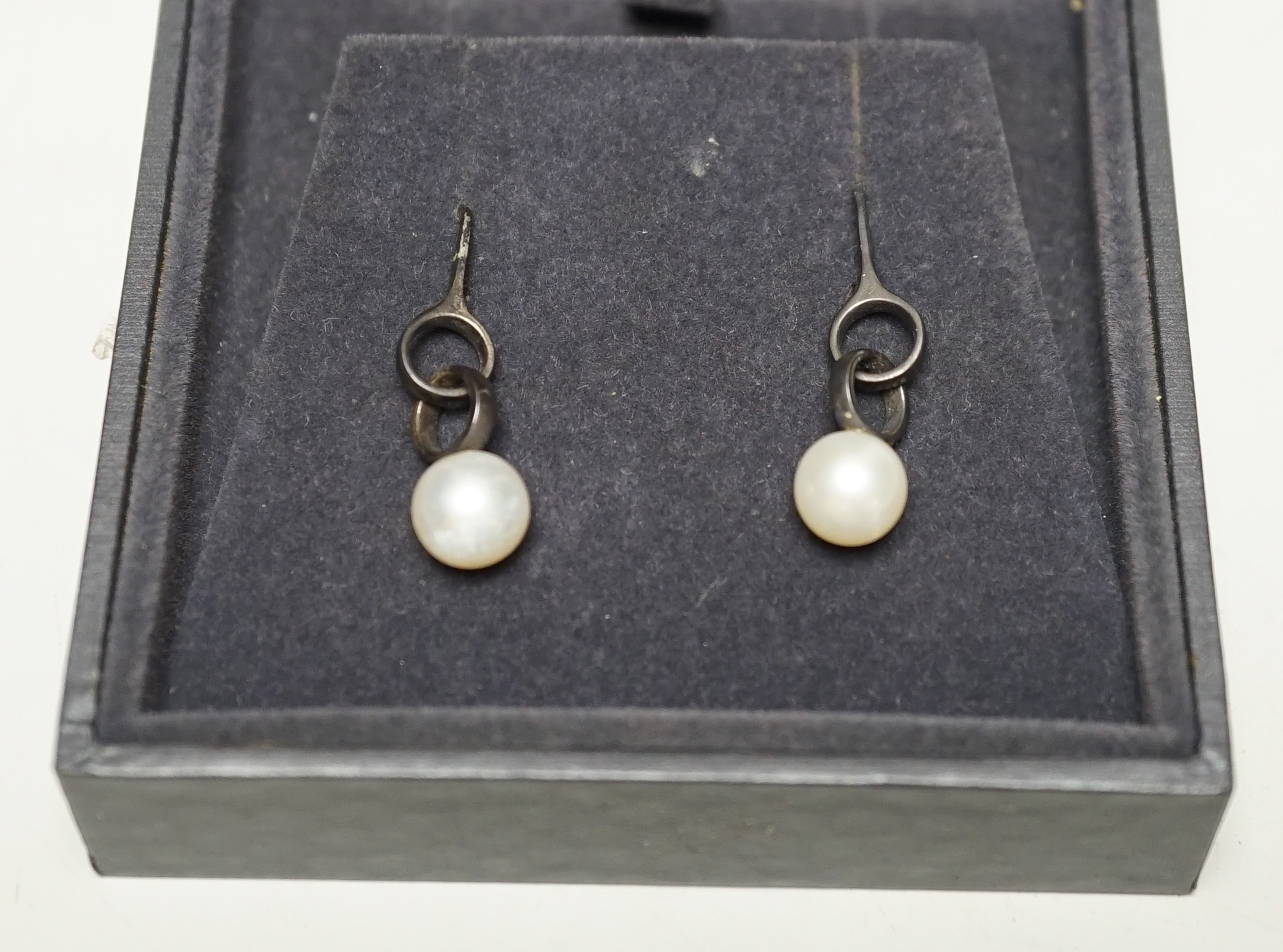 A modern pair of Georg Jensen silver and cultured pearl set drop earrings, 31mm, in Georg Jensen box.